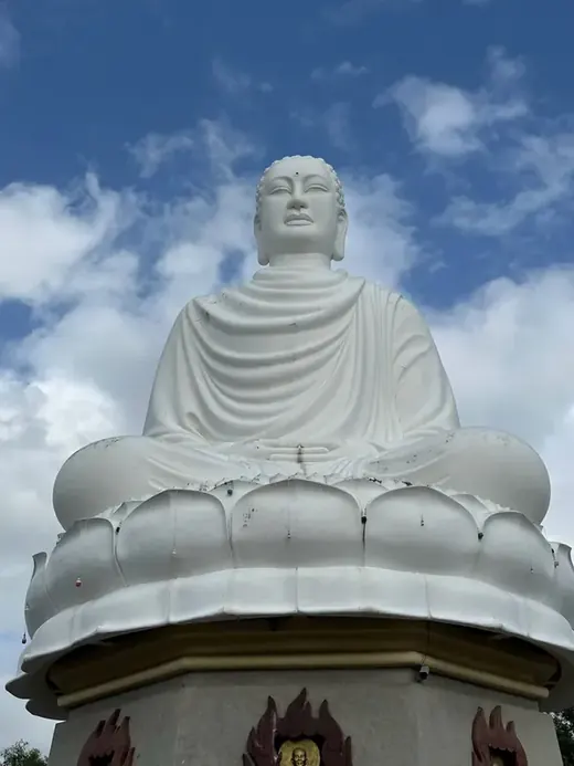 White Buddha statue against the sky